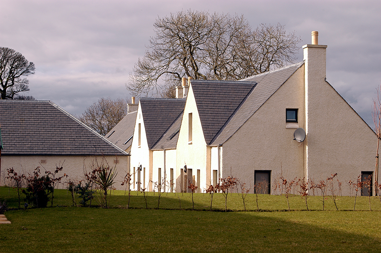 Viviendas encaladas en Dalmeny Steading, Escocia, con cubiertas de pizarra natural